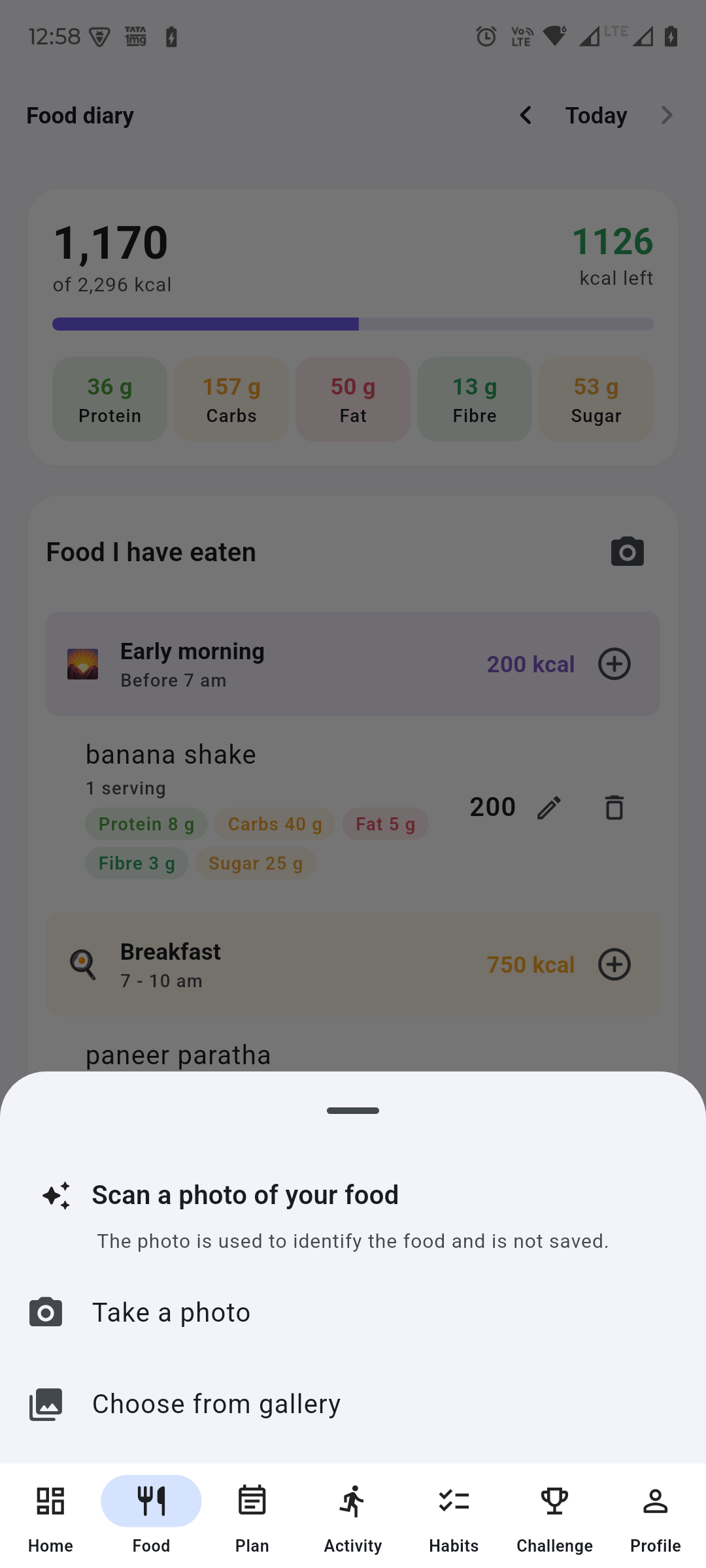 The scan sheet open over the food diary, headed “Scan a photo of your food” with the line “The photo is used to identify the food and is not saved”, offering to take a photo or choose one from the gallery